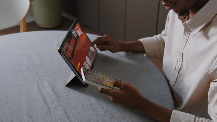 Person using tablet and phone for online shopping