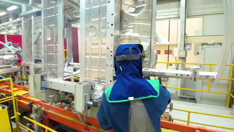 industrial workers car production factory facility, assembling line engine components in a factory to produce cars with the latest technology in modern auto manufacturing.