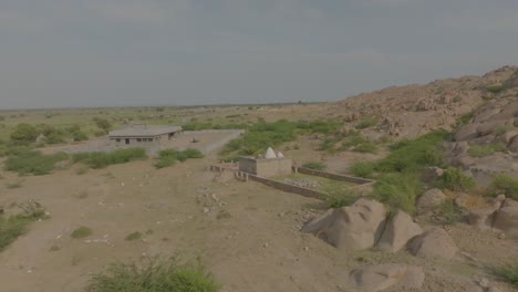 aerial shot of ruins of hindu temple in nagarparkar surrounded by stones in pakistan