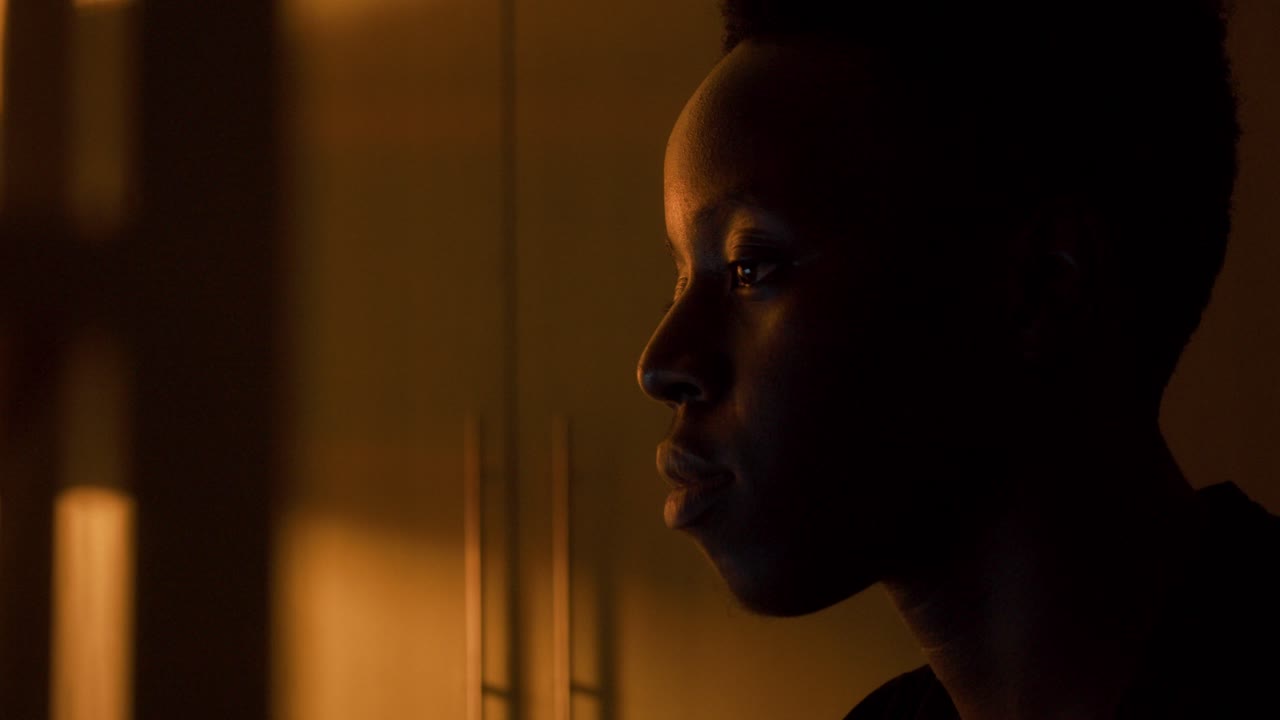 Young black man in using laptop computer at night