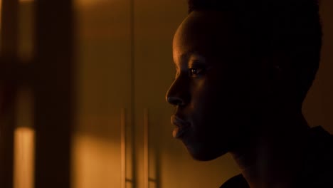 Young-black-man-in-using-laptop-computer-at-night