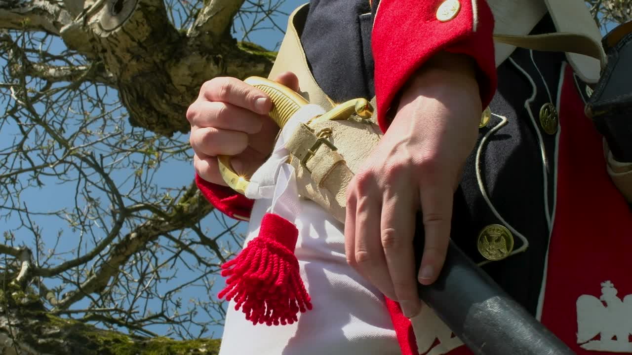 French Napoleon soldier sticks his sword in the holster. Battle of Waterloo
