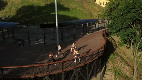 women exercising outdoors on a wooden walkway