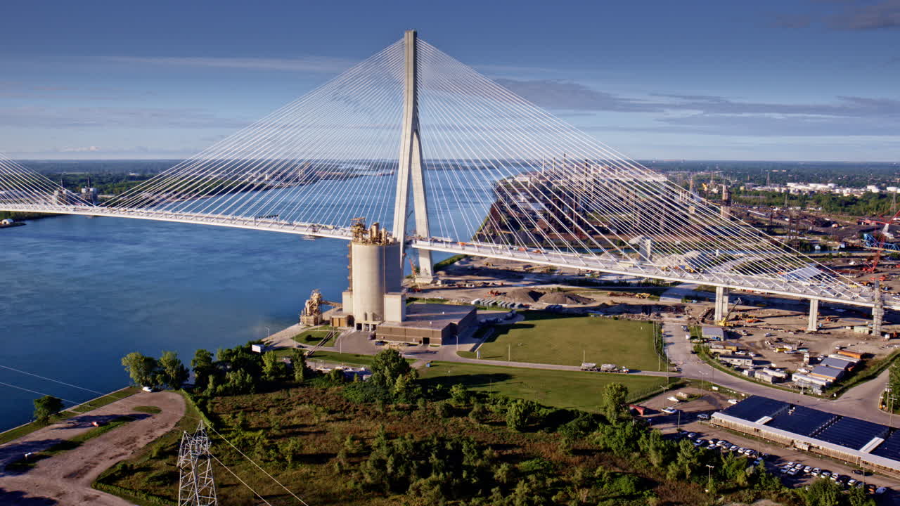 Drone flies above the new Gordie Howe Bridge, approaching Detroit's industrial corridor