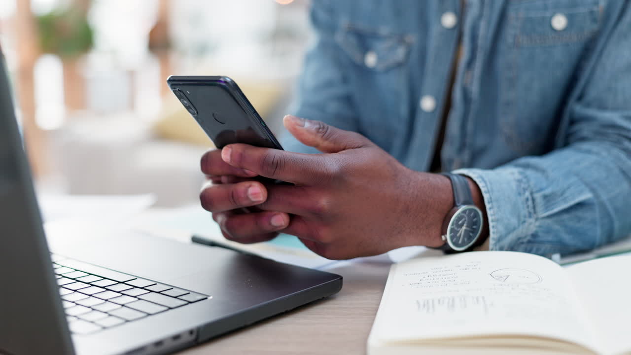 Phone, hands typing at table