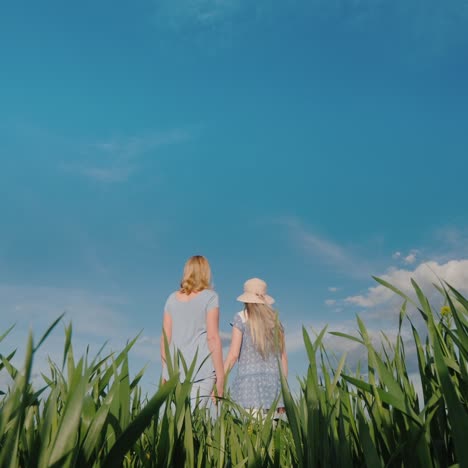 A-Woman-And-A-Child-Stand-Side-By-Side-Against-The-Backdrop-Of-A-Serene-Landscape