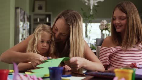 mother and daughters painting together