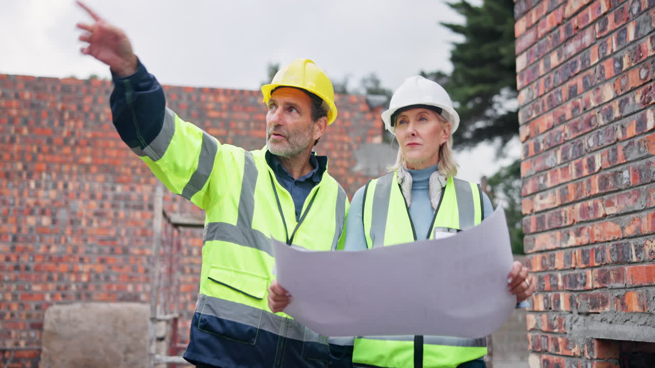 Construction workers reviewing plans on site