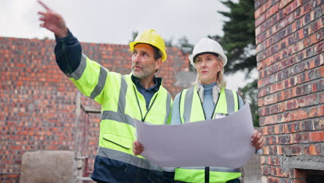 construction workers reviewing plans on site