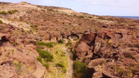 Natural-river-bed-surrounded-by-rock-formations-created-by-volcanic-erosion