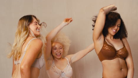 Group-Of-Women-Friends-One-With-Prosthetic-Limb-In-Underwear-Promoting-Body-Positivity-Dancing