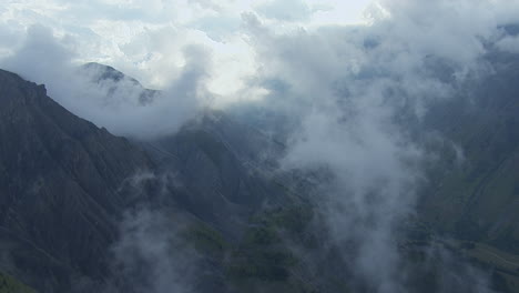 vanoise national park french alp mountain peaks, aerial flight in clouds