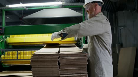 worker in a cardboard recycling plant