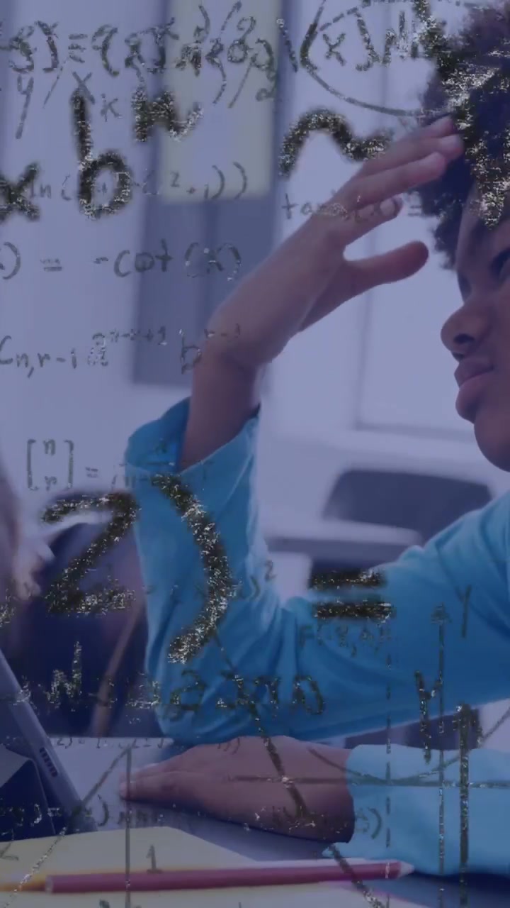 Vertical video: Boy touching transparent pane tracing math pointing to peer solving classroom task