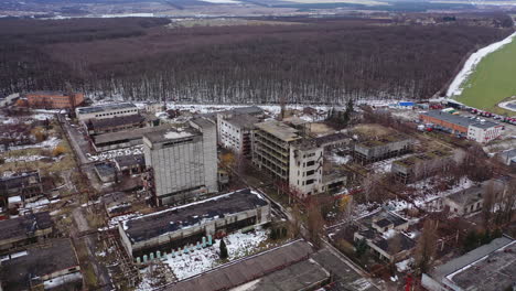 large territory of abandoned factory. old industrial buildings for demolition. ruined industrial zone on nature background. aerial view.