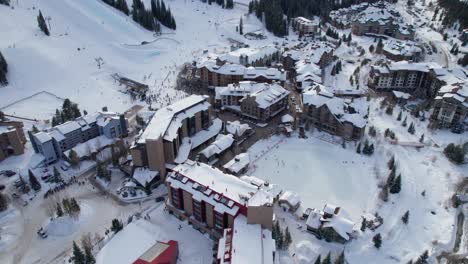 Drone-aerial-views-of-a-skating-rink-at-a-ski-resort-in-the-winter