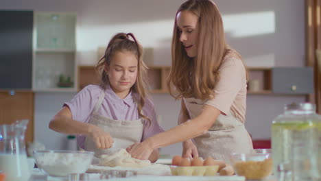 mother and daughter kneading