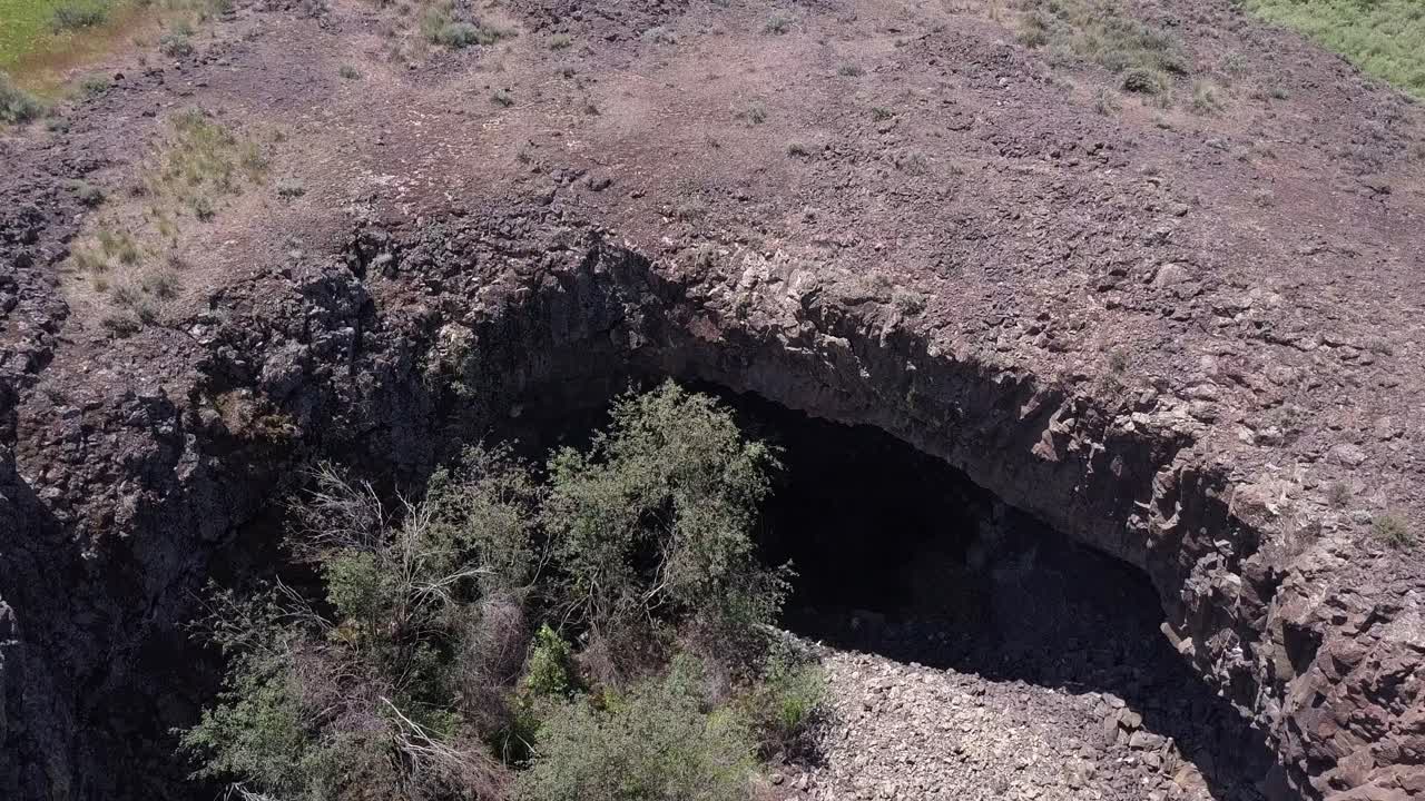 Aerial: Enormous cavern formed in huge eroded rock, scablands pothole