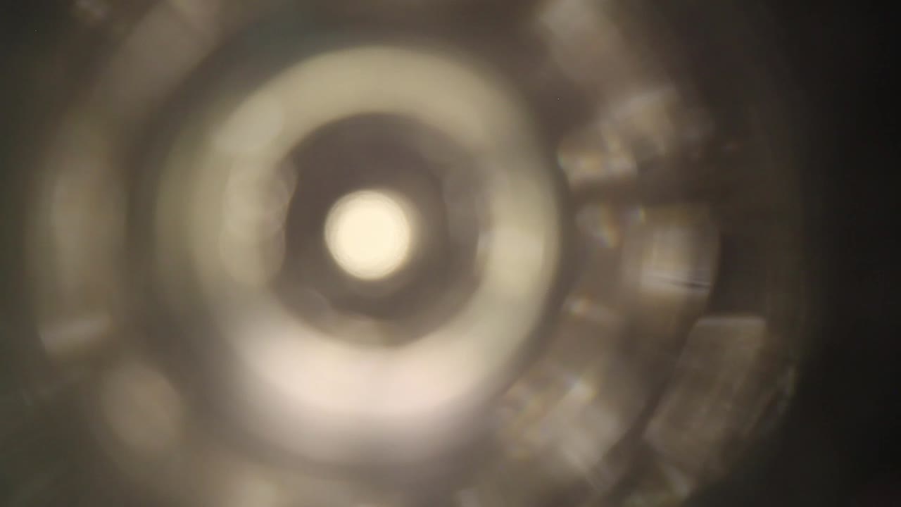 la luz arremolinada se mueve hacia un jarrón de vidrio transparente usando una lente de sonda de gran angular