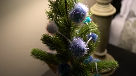 mini homemade christmas tree art at bed side table during evening