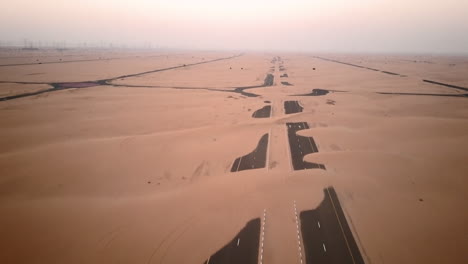 Aerial-view-of-abandoned-post-apocalyptic-roads-covered-in-sand-dunes