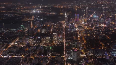 ho chi minh city, vietnam evening aerial time lapse featuring traffic, key buildings of skyline and saigon river under lights