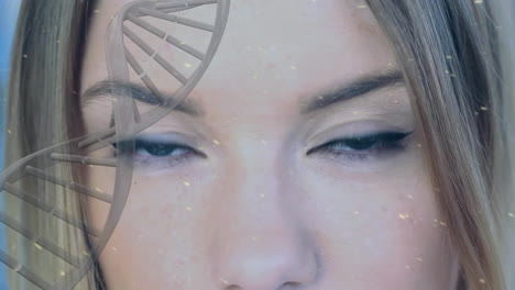 animation of dna strand and snow falling over caucasian woman opening eyes