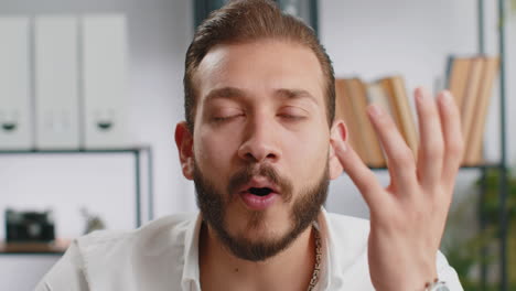 businessman working at home office taking off glasses shocked by sudden victory lottery winning