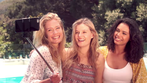 Attractive-friends-taking-selfie-by-the-pool