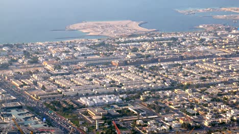 top view on cityscape with coastline of persian gulf in dubai, small cottages and roads with cars