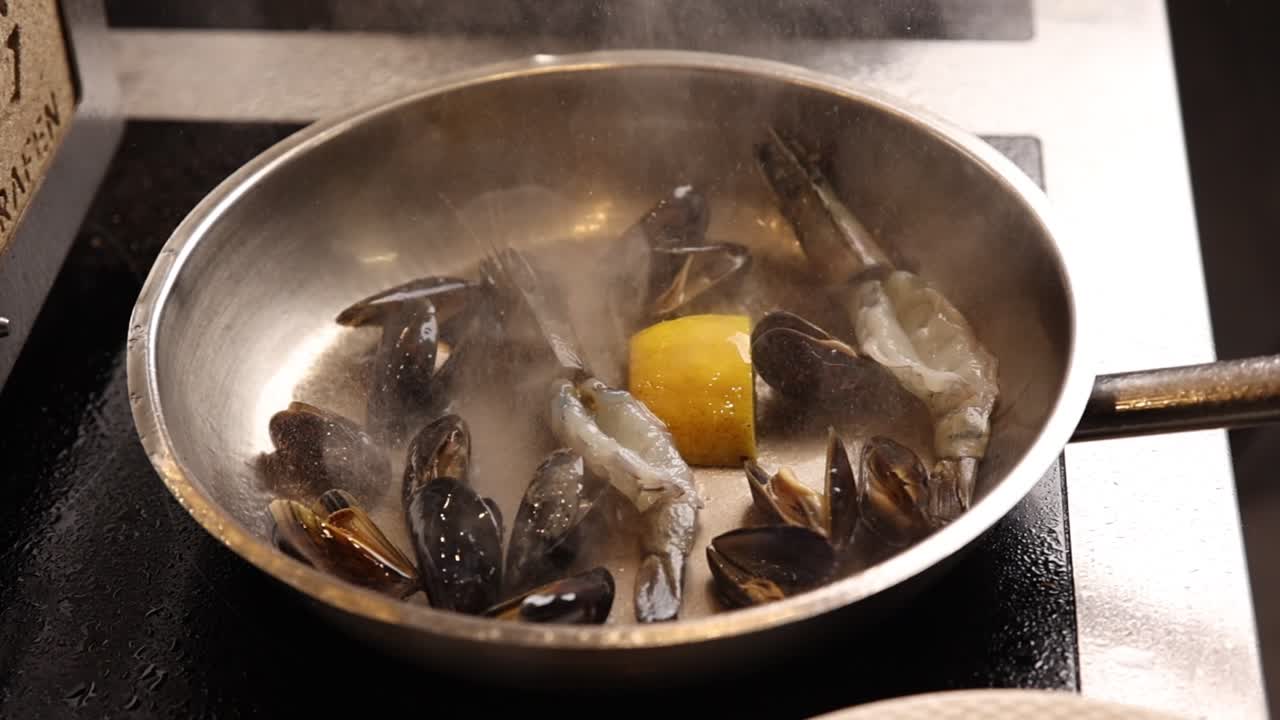 Fresh Mussels and Shrimp Cooking in a Steaming Pan with Lemon