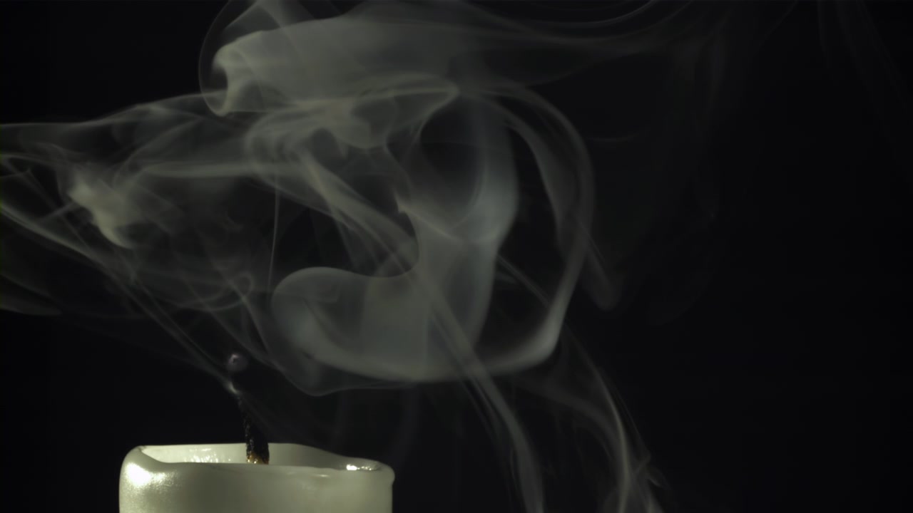 White Smoke Rising from an Extinguished Candle in Slow Motion