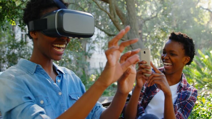 Twin sisters experiencing VR headset in the park 4k