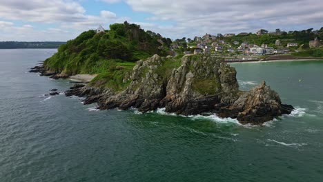 panoramic drone movement around the pointe du chateau rocky coastal endpoint with trestrignel beach, perros-guirec, brittany, france.