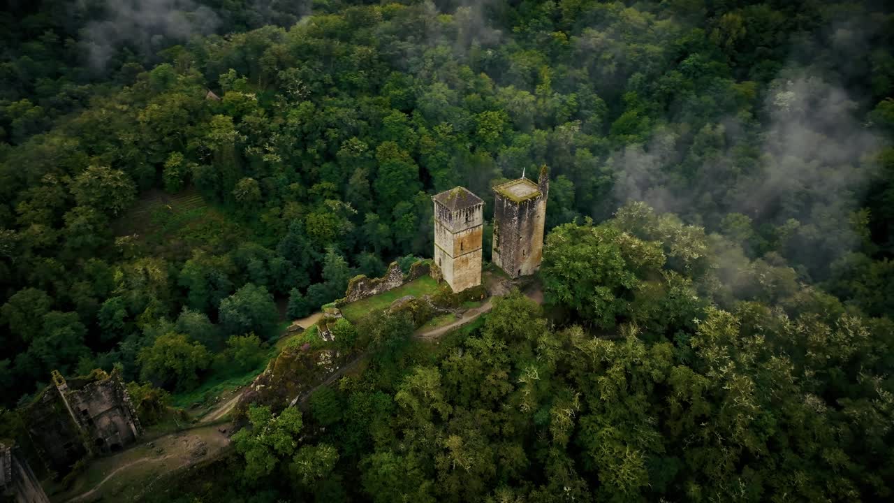 Aerial View of Ruined Castle in a Foggy Forest