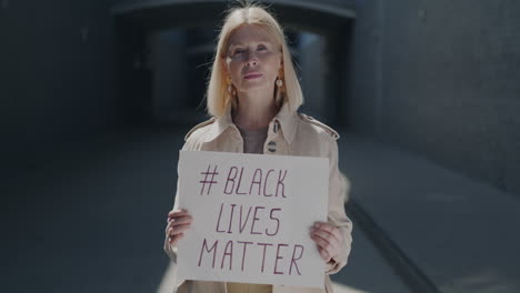 older woman holding black lives matter sign