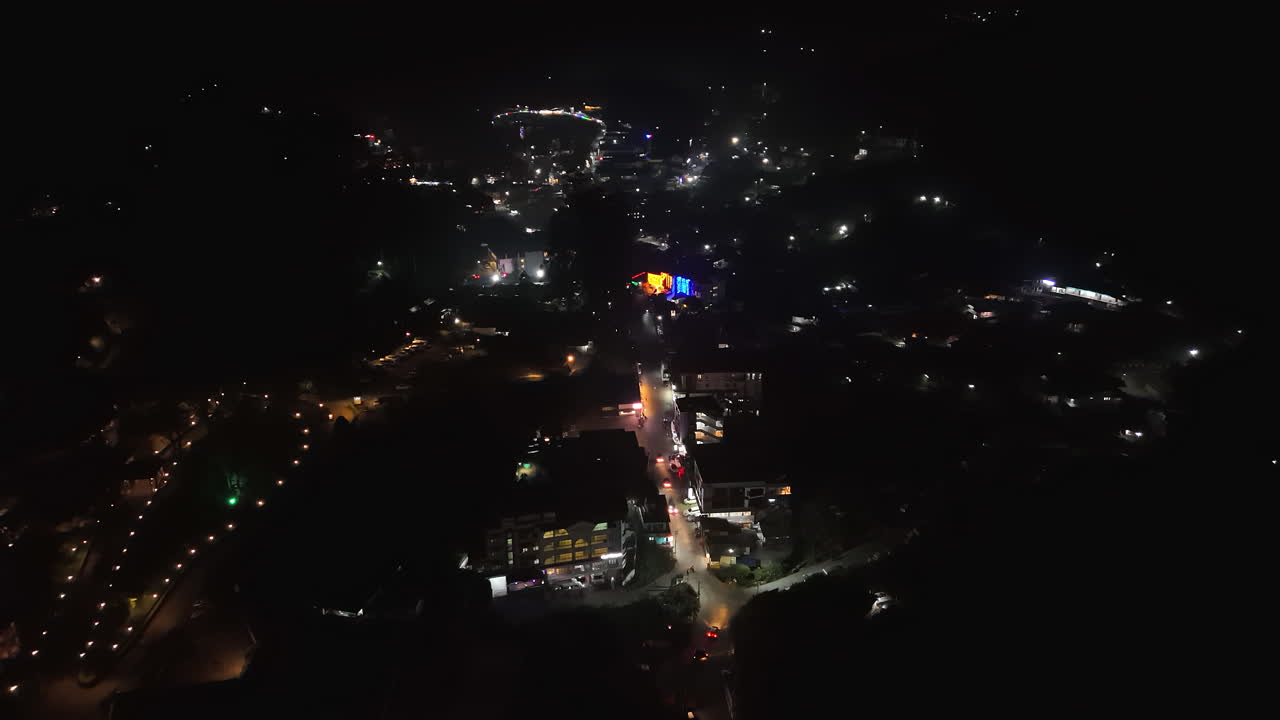 Aerial view overlooking the illuminated streets of Munnar, night in Kerala, India
