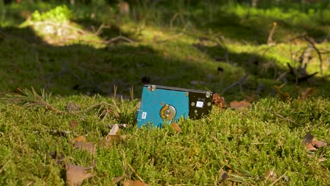 slide out shot of used computer hard drive as a pollution to the forest