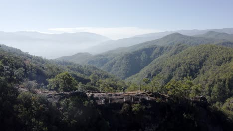 mountain hiker atop of amazing chinese mountain trail, panoramic aerial view