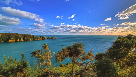 Sunset-timelapse-of-clouds-blowing-over-the-sea-by-the-Gurnsey-Island-in-the-English-Channel-off-the-coast-of-Normandy,-part-of-the-Bailiwick-of-Guernsey