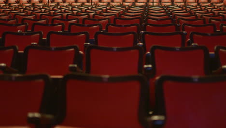 slow drift over empty red theater seats