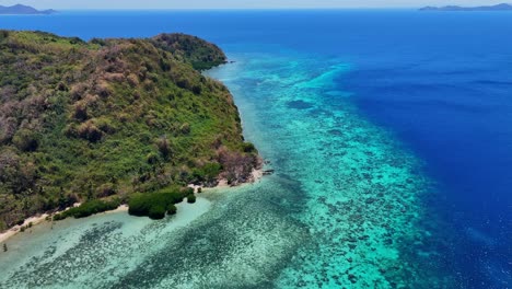 drone footage of a tropical coast with jungle, beach and boats near palawan in the philippines