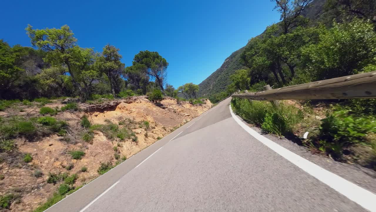 A POV shot as a cyclist descends down cornering at high speed on a remote mountain road, Catalunya Spain