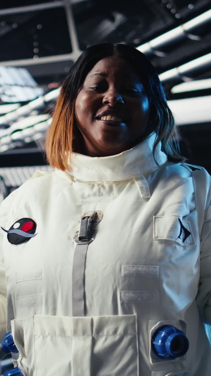 Vertical video Female astronaut performing routine maintenance in starship travelling to Mars