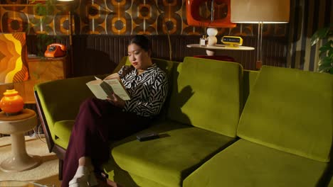 woman reading on a retro sofa