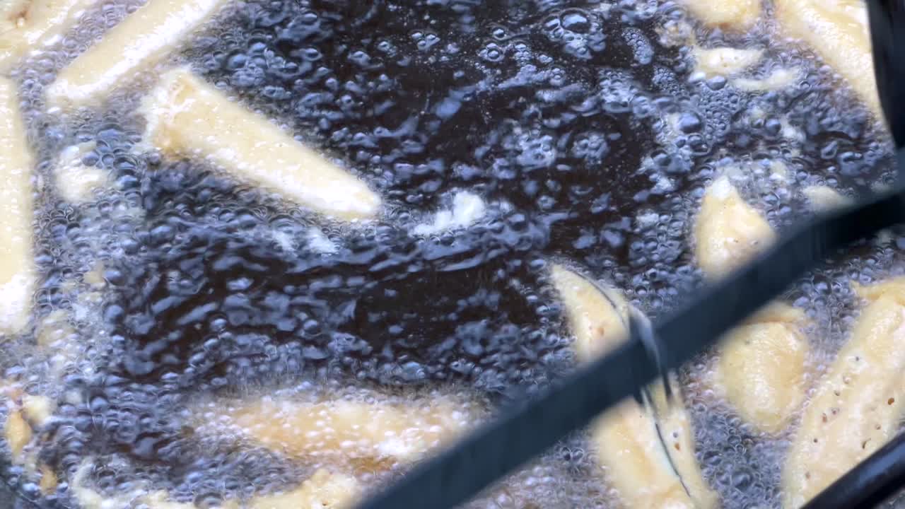 Close shot of Mans Hand cooking beguni with egg plant street food. Bangladeshi Street Food. Indian Street Food