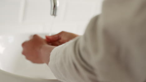 woman cleaning hands with soap