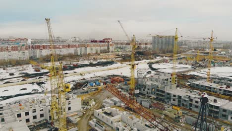 big-construction-cranes-located-in-line-on-ongoing-building