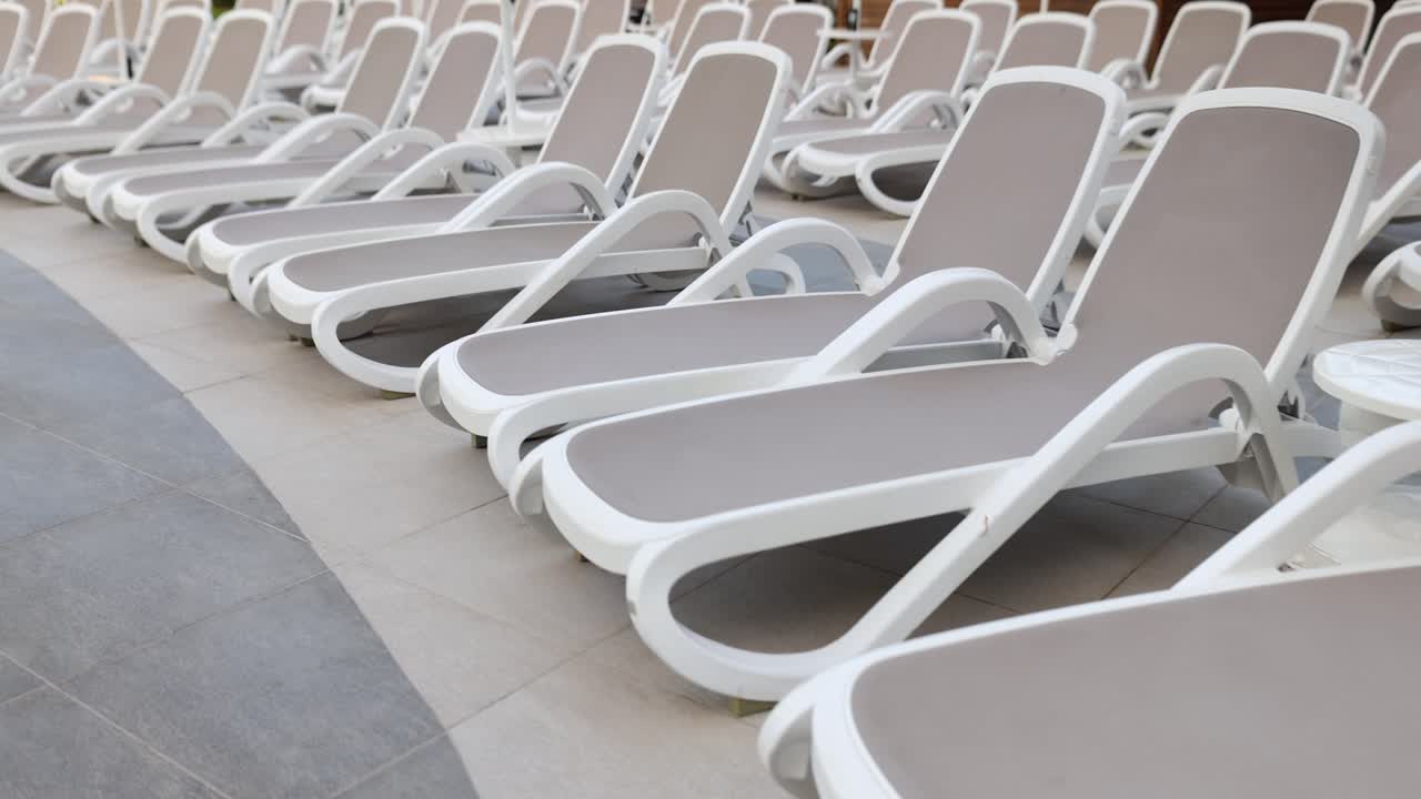 Plenty of modern sun loungers for vacationers at hotel pool