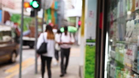 people walking on a bustling hong kong street